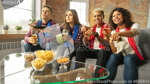 Image of Excited group of people watching sport match, championship at home