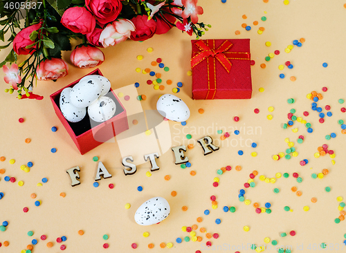 Image of Festive Easter card with a bouquet of roses and a red box