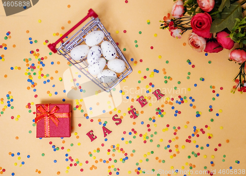 Image of Festive Easter card with a bouquet of roses and a red box