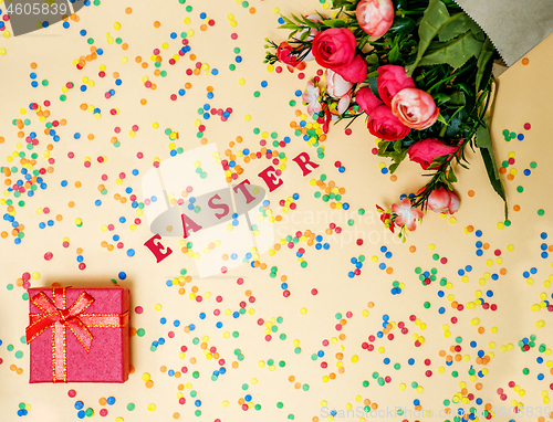 Image of Festive Easter card with a bouquet of roses and a red box