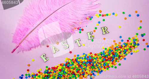 Image of Abstract easter card with scattered color confectionery balls and letters. Easter holiday concept.