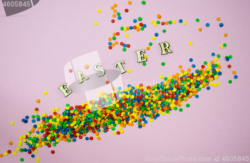 Image of Abstract easter card with scattered color confectionery balls and letters. Easter holiday concept.
