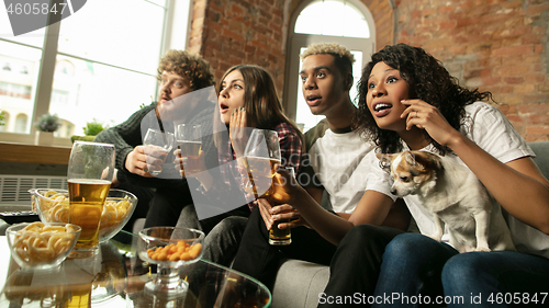 Image of Excited group of people watching sport match, championship at home