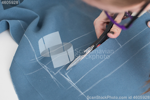 Image of Designer Cutting Fabric