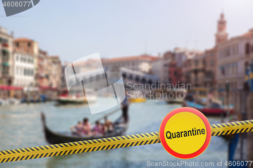 Image of Prohibition sign of quarantine with a police line on a blurred background of Rialto Bridge in Venice, Italy.