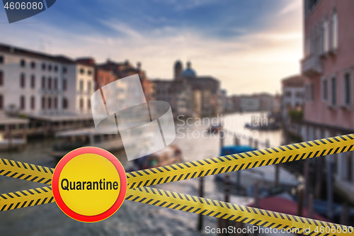 Image of Warning sign of quarantine on crossing police lines on a blurred background of Grand Canal in Venice, Italy.