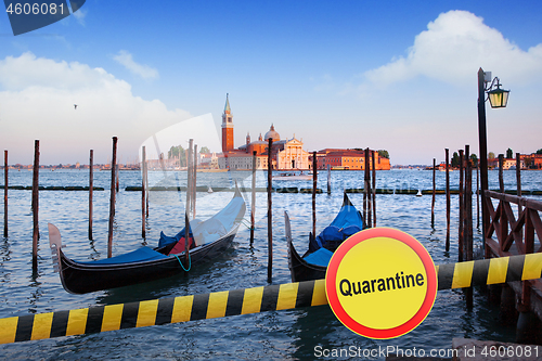 Image of Prohibition yellow sign of quarantine on the background of San Giorgio Maggiore church in Venice, Italy.