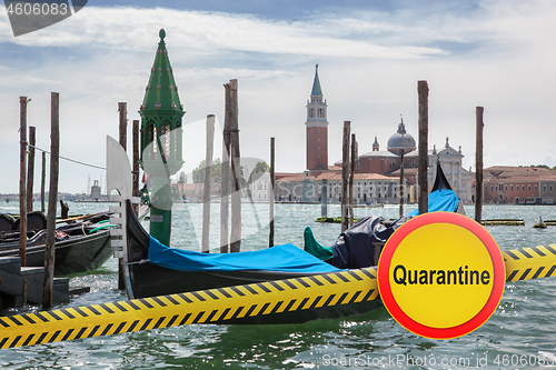 Image of Prohibition yellow sign of quarantine on the background of San Giorgio Maggiore church in Venice, Italy.