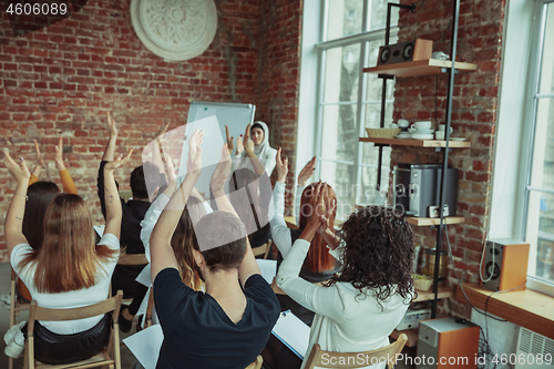 Image of Female muslim speaker giving presentation in hall at university workshop