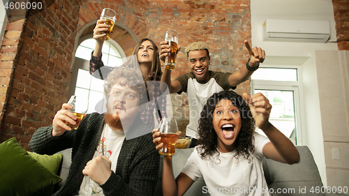 Image of Excited group of people watching sport match, championship at home