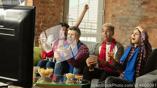 Image of Excited group of people watching sport match, championship at home