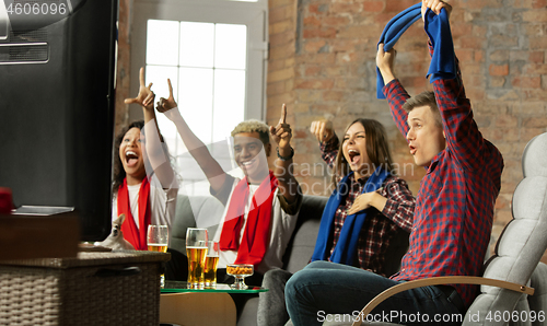 Image of Excited group of people watching sport match, championship at home