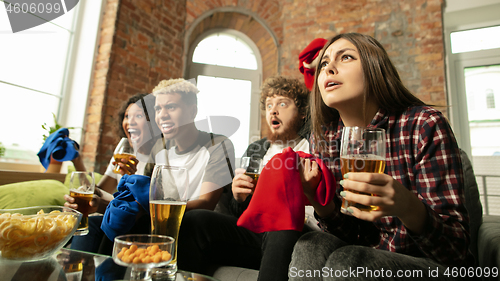 Image of Excited group of people watching sport match, championship at home