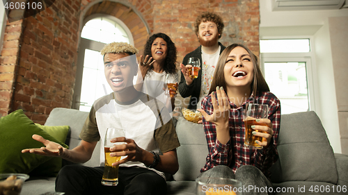 Image of Excited group of people watching sport match, championship at home