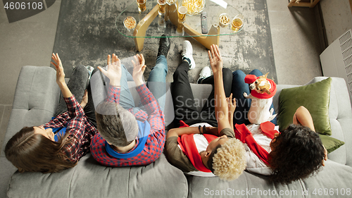 Image of Excited group of people watching sport match, championship at home