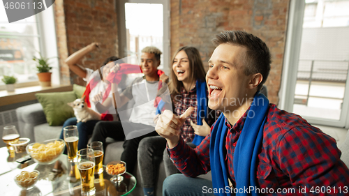 Image of Excited group of people watching sport match, championship at home