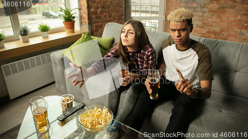 Image of Excited couple, friends watching sport match, championship at home