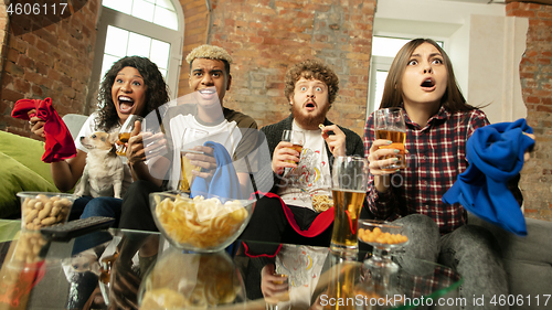 Image of Excited group of people watching sport match, championship at home