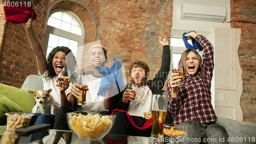 Image of Excited group of people watching sport match, championship at home