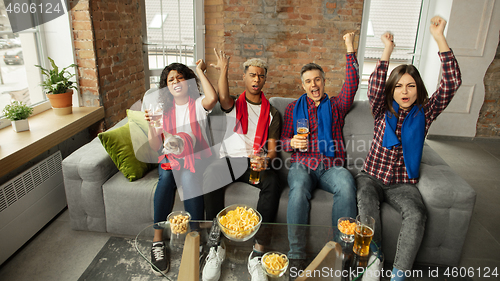 Image of Excited group of people watching sport match, championship at home