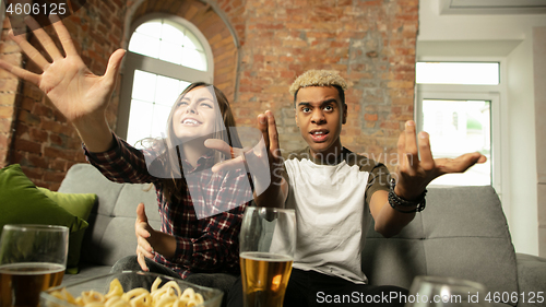 Image of Excited couple, friends watching sport match, championship at home