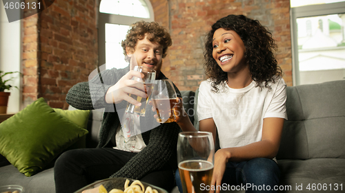 Image of Excited couple, friends watching sport match, championship at home