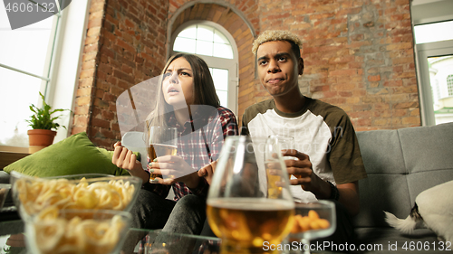 Image of Excited couple, friends watching sport match, championship at home
