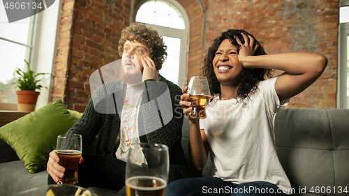 Image of Excited couple, friends watching sport match, championship at home