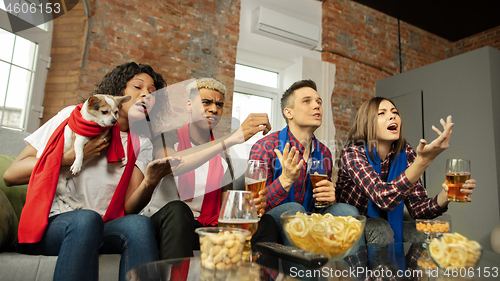 Image of Excited group of people watching sport match, championship at home