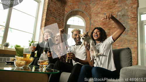 Image of Excited group of people watching sport match, championship at home