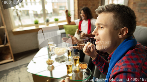 Image of Excited group of people watching sport match, championship at home