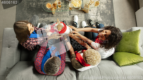 Image of Excited group of people watching sport match, championship at home