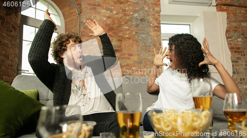 Image of Excited couple, friends watching sport match, championship at home