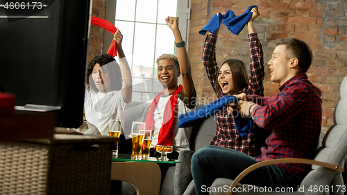 Image of Excited group of people watching sport match, championship at home