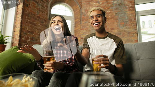 Image of Excited couple, friends watching sport match, championship at home