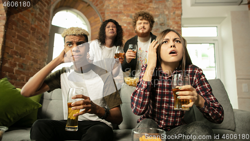 Image of Excited group of people watching sport match, championship at home