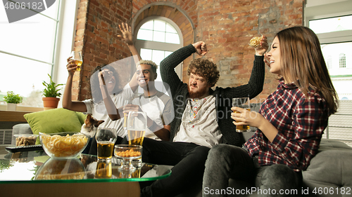 Image of Excited group of people watching sport match, championship at home