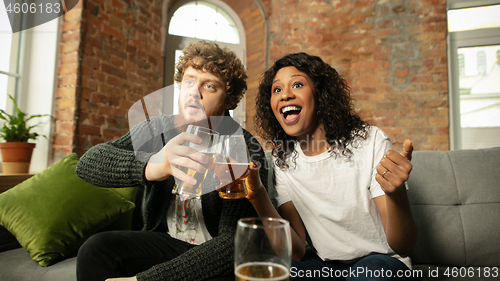 Image of Excited couple, friends watching sport match, championship at home