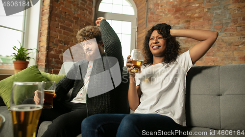 Image of Excited couple, friends watching sport match, championship at home