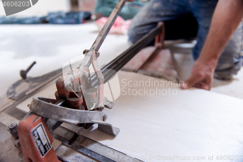 Image of worker cutting the ceramic wood effect tiles