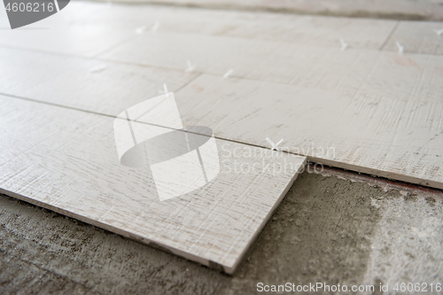 Image of Ceramic wood effect tiles and tools for tiler on the floor