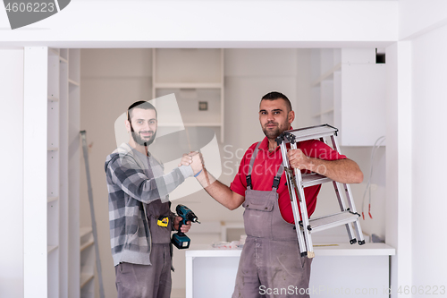 Image of workers giving high five to each other