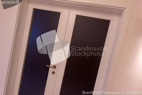 Image of double glass door with white wooden frame