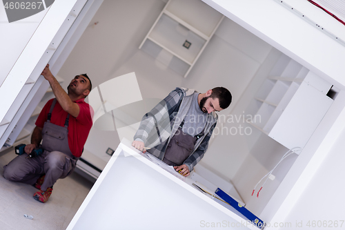 Image of workers installing a new kitchen