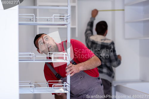 Image of workers installing a new kitchen