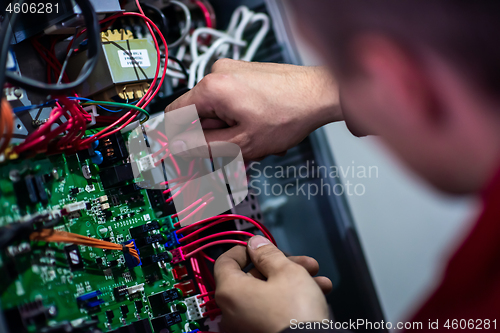 Image of electrician engineer working with electric cable wires