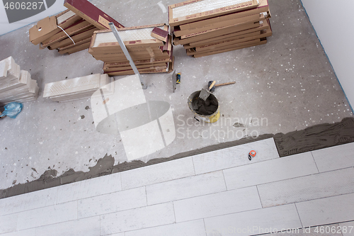 Image of Ceramic wood effect tiles and tools for tiler on the floor