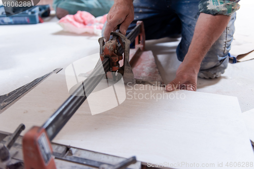 Image of worker cutting the ceramic wood effect tiles