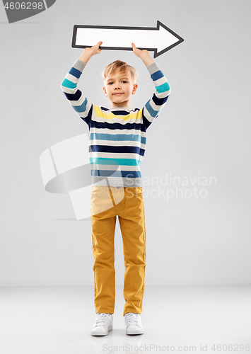 Image of boy holding big white rightwards thick arrow