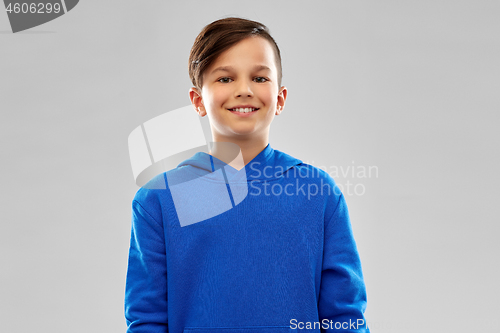 Image of portrait of smiling boy in blue hoodie